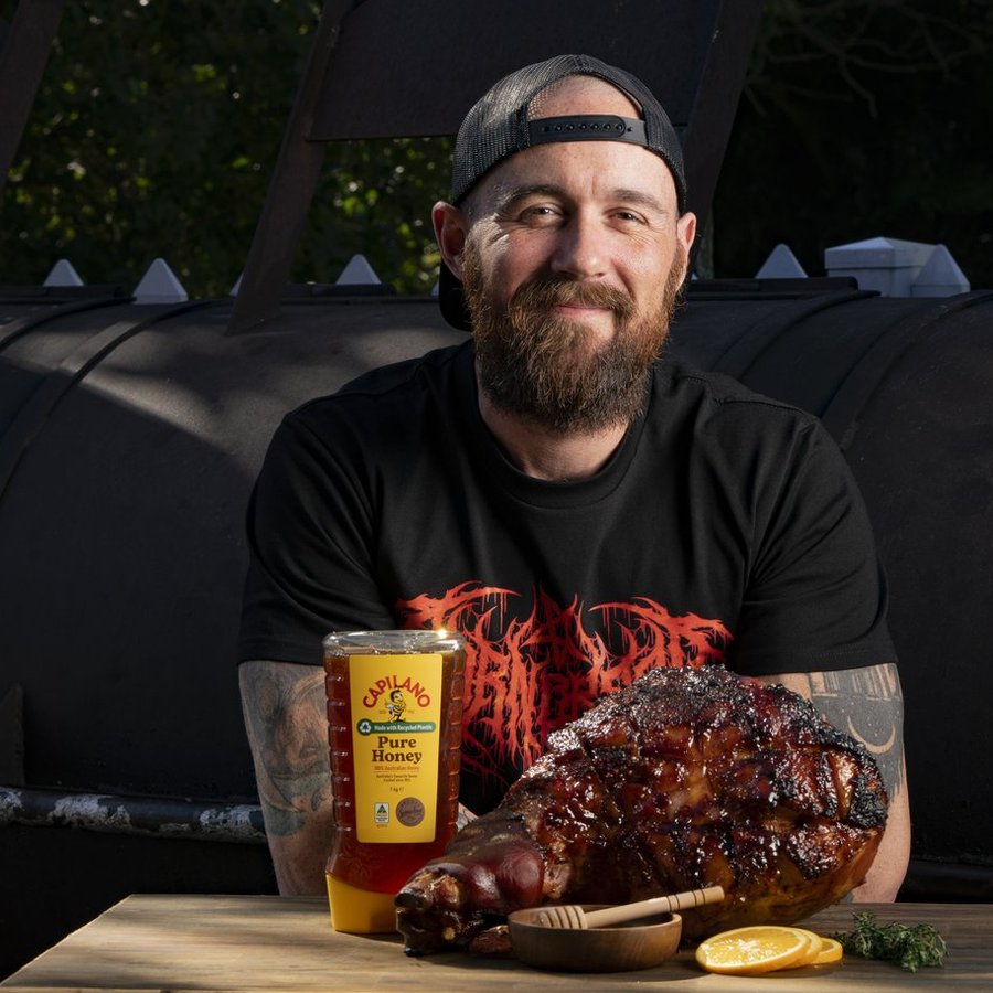 Sam Herbert at his smoker with a glazed ham